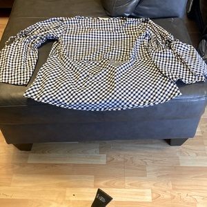 Black and White checkered shirt with sleeves open both sides and it ties up arm